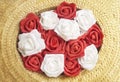 Beautiful bouquet red and white rose flowers on straw hat. Royalty Free Stock Photo