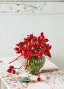 Beautiful bouquet of rose hips in vintage glass vase as autumn decoration. Royalty Free Stock Photo