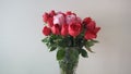 Beautiful bouquet of roses in jars on table with white background. Wedding bouquet of red rose