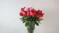 Beautiful bouquet of roses in jars on table with white background. Wedding bouquet of red rose