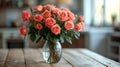 A beautiful bouquet of roses stands in a glass vase on a wooden table Royalty Free Stock Photo