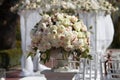 Beautiful bouquet of roses in a vase on a background of a wedding arch. Beautiful set up for the wedding ceremony. Royalty Free Stock Photo