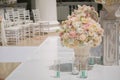 Beautiful bouquet of roses in a vase on a background of a wedding arch. Beautiful set up for the wedding ceremony. Royalty Free Stock Photo