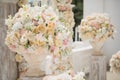 Beautiful bouquet of roses in a vase on a background of a wedding arch. Beautiful set up for the wedding ceremony Royalty Free Stock Photo