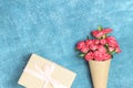 Beautiful bouquet of small red roses in vintage paper on the table. Royalty Free Stock Photo