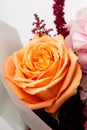 Beautiful bouquet with soft pink Hydrangea Hydrangea macrophylla or Hortensia flower, mild orange roses and red wrapping paper. Royalty Free Stock Photo