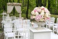 Beautiful bouquet in stone vase in front of wedding arch