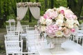 Beautiful bouquet in stone vase in front of wedding arch