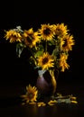 Beautiful bouquet of sunflowers in vase on a black table over black background Royalty Free Stock Photo