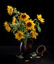 Beautiful bouquet of sunflowers in vase on a black table over black background Royalty Free Stock Photo