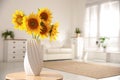 Beautiful bouquet of sunflowers in vase on table indoors. Space for text Royalty Free Stock Photo