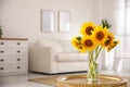 Beautiful bouquet of sunflowers in vase on table indoors. Space for text Royalty Free Stock Photo