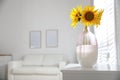 Beautiful bouquet of sunflowers in vase on table indoors. Space for text Royalty Free Stock Photo