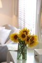 Beautiful bouquet of sunflowers in vase on white table indoors. Space for text Royalty Free Stock Photo