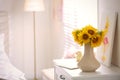 Beautiful bouquet of sunflowers in vase on white table indoors. Space for text Royalty Free Stock Photo