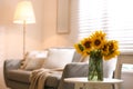 Beautiful bouquet of sunflowers in vase on white table indoors. Space for text Royalty Free Stock Photo