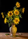 Beautiful bouquet of sunflowers in vase on a wooden table Royalty Free Stock Photo