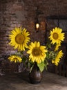 Beautiful bouquet of sunflowers in vase on a wooden table Royalty Free Stock Photo
