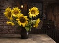 Beautiful bouquet of sunflowers in vase on a wooden table Royalty Free Stock Photo