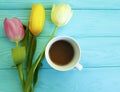 Beautiful bouquet of tulips on blue wooden, March 8, cup of coffee present anniversary natural decorative March 8