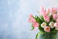 Beautiful bouquet of tulips in glass vase against light background. Space for text Royalty Free Stock Photo