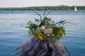 Beautiful bouquet of wreath of wild flowers on the head of a girl near the water river Royalty Free Stock Photo