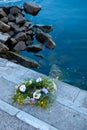 A beautiful bouquet of a wreath of wild flowers lies on stone steps Royalty Free Stock Photo