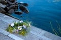 A beautiful bouquet of a wreath of wild flowers lies on stone steps