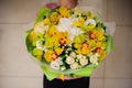 Beautiful bouquet of yellow flowers in hands the girl