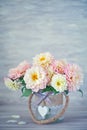 Beautiful bouquet of a yellow and pink dahlias .