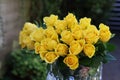 Beautiful bouquet of yellow roses in glass vase outdoors, closeup Royalty Free Stock Photo