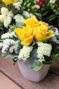 A beautiful bouquet of yellow roses and white kermek flowers in the vase. Royalty Free Stock Photo
