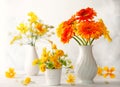 Beautiful bouquet of red and yellow flowers in white vase on wooden table, front view. Autumn still life with flowers