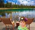 The beautiful boy on the bank of round lake