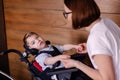 Beautiful boy child in a special wheelchair. Toddler with cerebral palsy Royalty Free Stock Photo