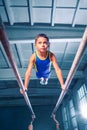 Beautiful boy is engaged in sports gymnastics on a parallel bars