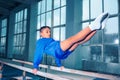 Beautiful boy is engaged in sports gymnastics on a parallel bars