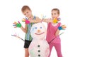 Beautiful boy and girl with hands in paint near color snowman with colored horns and hands Royalty Free Stock Photo