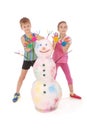 Beautiful boy and girl with hands in paint near color snowman with colored horns and hands Royalty Free Stock Photo