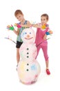 Beautiful boy and girl with hands in paint near color snowman with colored horns and hands Royalty Free Stock Photo