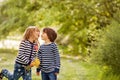 Beautiful boy and girl in a park, boy giving flowers to the girl Royalty Free Stock Photo