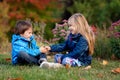 Beautiful boy and girl in a park, boy giving flowers to the girl Royalty Free Stock Photo