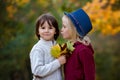 Beautiful boy and girl in a park, boy giving flowers to the girl Royalty Free Stock Photo
