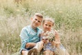 Beautiful boy and girl in a park, boy giving flowers to the girl. Friendship concept Royalty Free Stock Photo