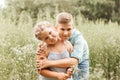 Beautiful boy and girl in a park, boy giving flowers to the girl. Friendship concept Royalty Free Stock Photo