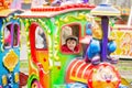 Beautiful boy having fun on the ride at the amusement park Royalty Free Stock Photo
