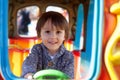 Beautiful boy having fun on the ride at the local carnival Royalty Free Stock Photo