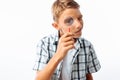 Beautiful boy looking through a magnifying glass, a teenager in search of, in Studio, closeup Royalty Free Stock Photo