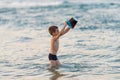 Beautiful boy playing with a bucket toy in the sea Royalty Free Stock Photo