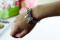 Beautiful bracelet made of colorful stones on elegant female hand  on white background Royalty Free Stock Photo